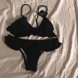 Black bathing suit with ruffles.